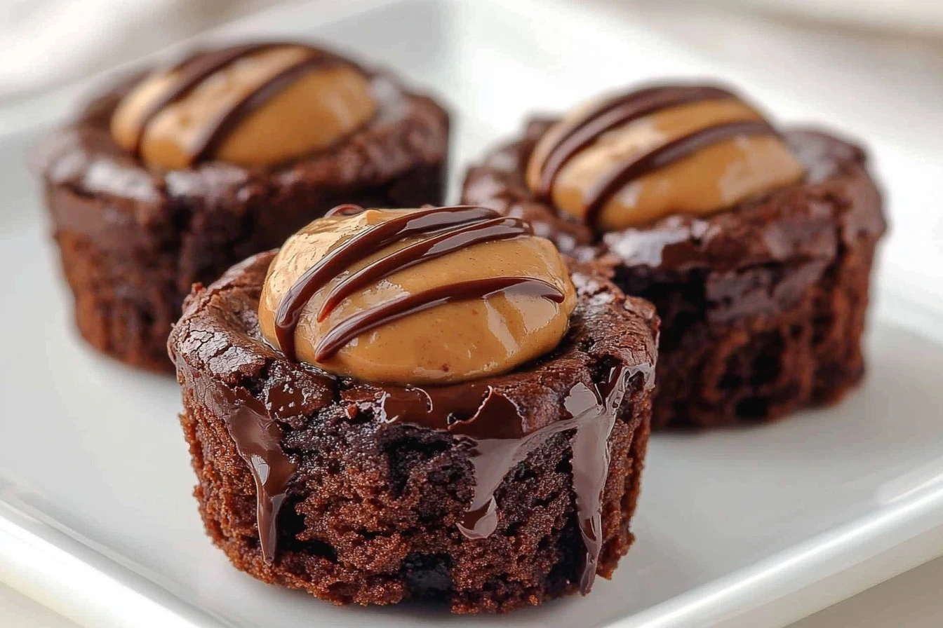 Decadent Buckeye Brownie Bites served on a plate, garnished with chocolate drizzle.