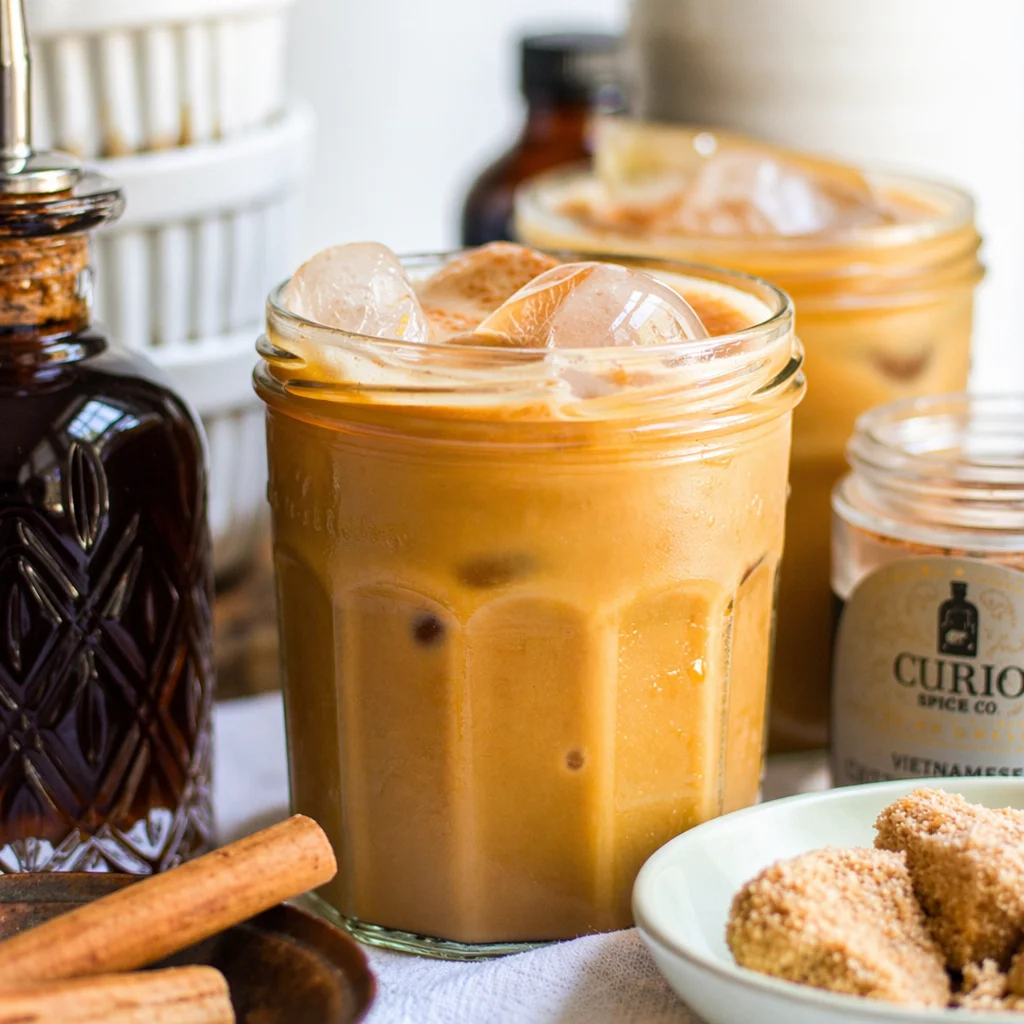 Iced Brown Sugar Cinnamon Coffee Mocktail with frothy oat milk and espresso