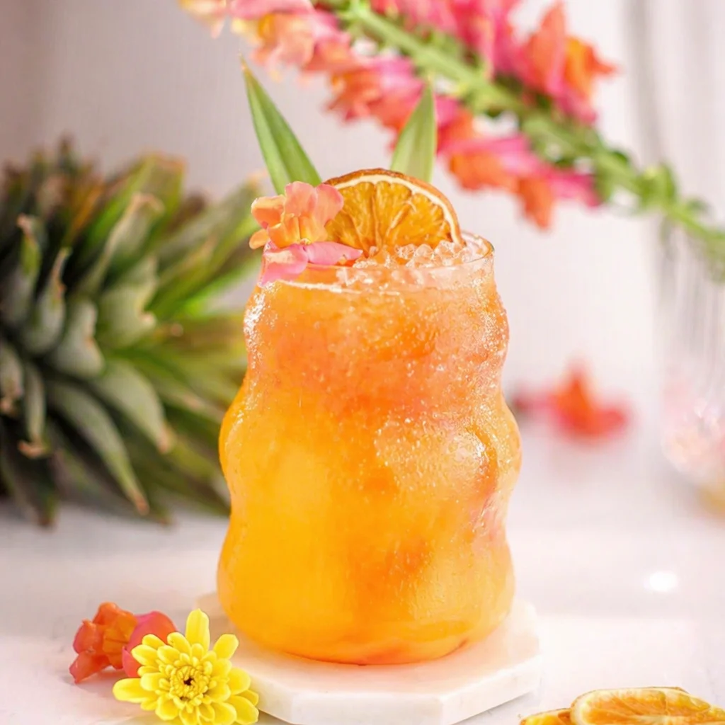 Refreshing Sparkling Mango Pineapple Summer Mocktail with fresh fruits and sparkling water